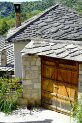 Traditional architecture in Pocitelj, Bosnia and Herzegovina: gates and old houses with stone slab roofs. The atmosphere of antiquity in Bosnia and Herzegovina - visiting historical places.