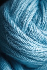 Fototapeta premium The deep tones and textured surface of dark blue yarn create a striking backdrop for showcasing knitting materials.