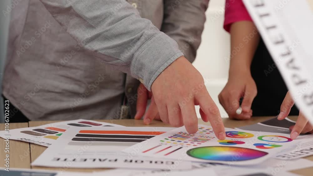 Aufkleber slow motion hand closeup of designer team brainstorming and choosing color for graphic design workin