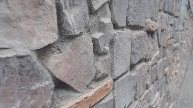 A Detailed CloseUp View of a Textured Stone Wall Showcasing Its Natural Variation Features