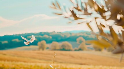 Obraz premium Serene landscape with white dove in flight symbolizing peace and ceasefire, calm blue sky, distant mountains, and single olive branch in foreground. 