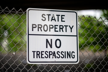 State Property No Trespassing Sign Attached to a Chain-Link Fence