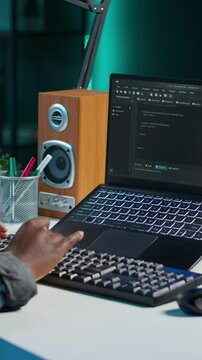 Vertical video Freelancing admin in home office using laptop to write programming language code. Software technician working from home using notebook device to build application, camera A