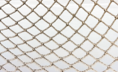 Frozen football net network in the winter up close