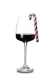 Glass of wine with Christmas decor on white background