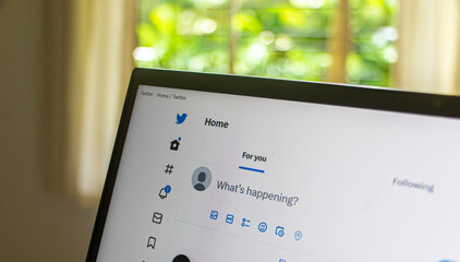 Create twitter post on laptop screen close up view