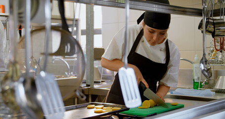 Female chef working in kitchen at restaurant 4k