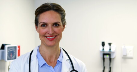 Portrait of female doctor holding clipboard at hospital