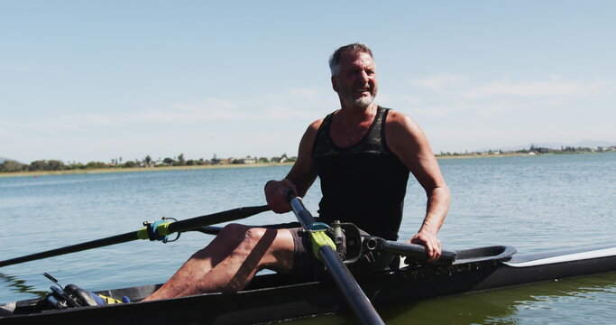 Senior caucasian man preparing rowing boat in a river