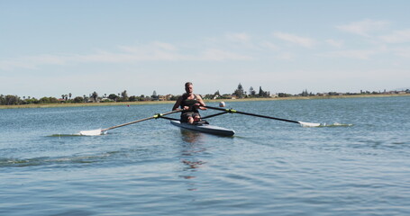 Senior caucasian man rowing boat on a river