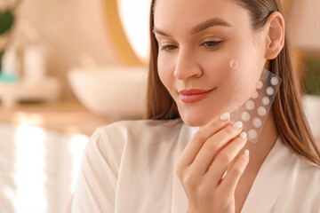 Young woman with pimple patches in bathroom, closeup