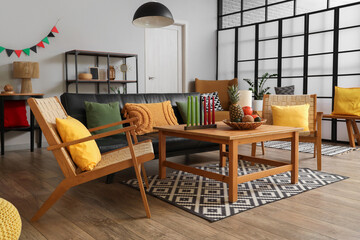 Interior of living room decorated for Kwanzaa celebration with sofa, armchairs and table