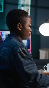 Vertical video AI professional in home office using laptop to write programming language code. Artificial intelligence engineer working from home using notebook device to build application, camera B