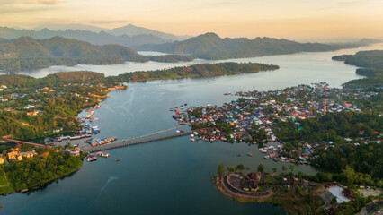 Aerial  Mon Bridge floating house village Sangkhlaburi Thailand drone above travel destination...