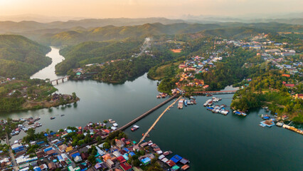 drone fly above Mon bridge village in Sangkhlaburi Thailand aerial at sunset 