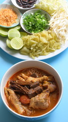 rice vermicelli with northern thai curry sauce on blue background