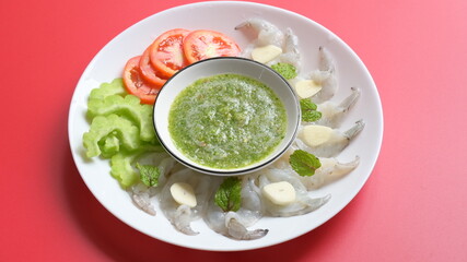 shrimp in fish sauce with Thai spicy seafood dipping sauce on white plate