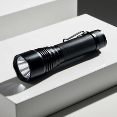 Create a sharp and engaging image of a classic black flashlight resting on a clean, white surface. The flashlight should have a sleek design, emphasizing its shiny metallic reflector and textured grip
