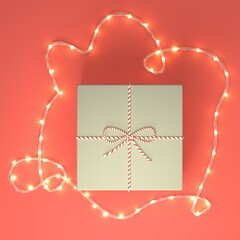 Christmas gift box flat lay, layout template with fairy lights garland. Ad mock up with copy space. Hipster style craft paper gift box with twine, Christmas gift box background. Holiday background