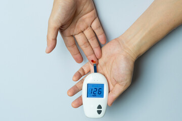 Title	
Woman's hands checking diabetes and hyperglycemia with digital blood sugar meter. Healthcare and medical concept	
