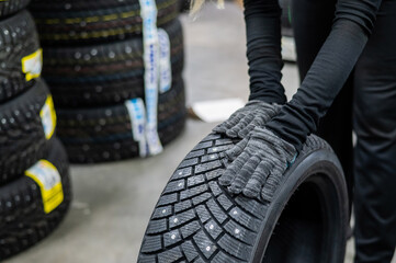 Mechanic keeps new studded car tires in garage. 