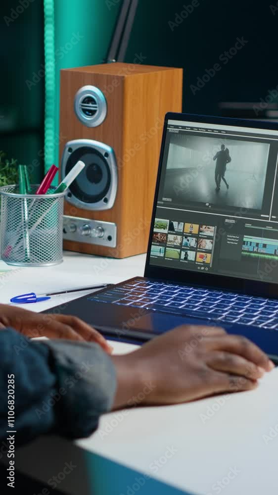 Poster vertical video video editor selecting key frames to use while doing video montage, working from home