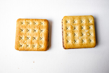 Sandwich biscuits with chocolate filling on white background