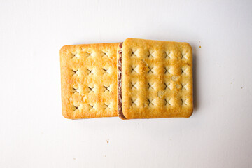 Sandwich biscuits with chocolate filling on white background