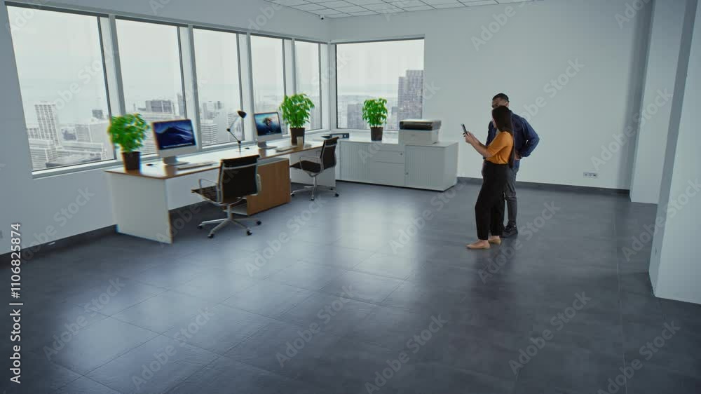 Poster multiethnic team of two designers using app on tablet computer to design interior in office room wit
