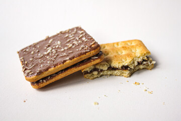 Bitten chocolate sandwich biscuit on white background