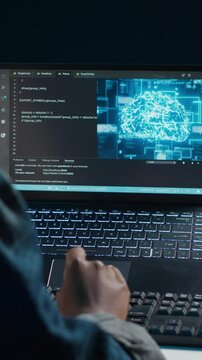 Vertical video AI professional in home office using laptop to write programming language code. Artificial intelligence engineer working from home using notebook device to build application, camera A