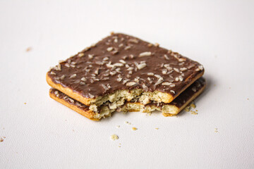Bitten chocolate sandwich biscuit on white background