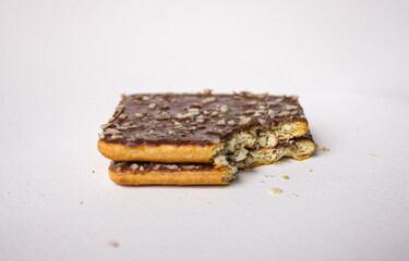 Bitten chocolate sandwich biscuit on white background