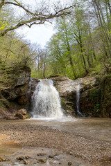 Obraz premium a waterfall in the summer, rushing streams and jets of water and turned into a huge shower of water