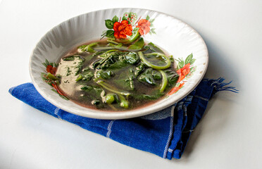Sayur Bening Bayam Merah or Red Spinach Clear Soup served in a white bowl