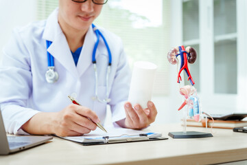 A male doctor sits at a desk in a hospital, discussing male urinary tract models and conditions...