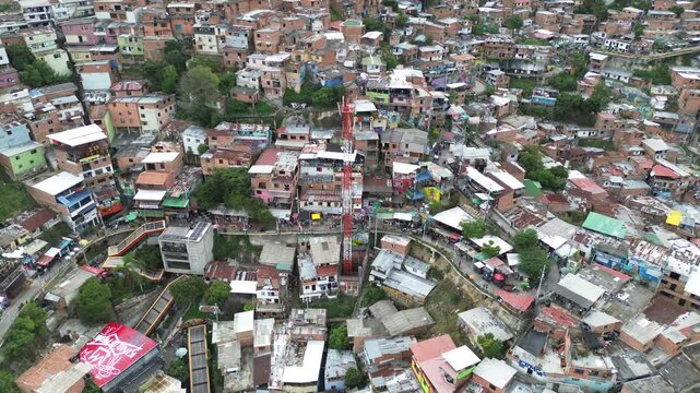 Top-down aerial overview of Comuna 13 in Medellin, Colombia, vibrant urban density and design with packed ramshackle homes