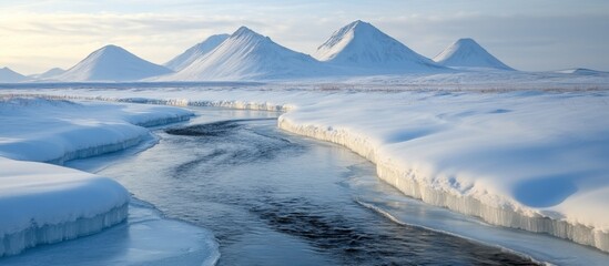 ** Majestic Snow-Covered Mountains and Serene River in Winter Landscape at Sunrise

**