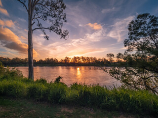 Golden Sunset Over The River with Cloud Reflections