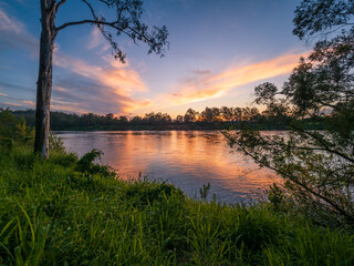 Golden Sunset Over The River with Cloud Reflections
