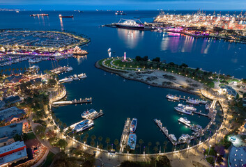Long Beach Rainbow Harbor at dusk with boats docked in a circle.