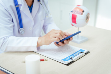 A male doctor wearing glasses sits at a desk in a hospital, explaining eye diseases like glaucoma, cataracts, pterygium, and diabetic retinopathy. Early detection helps prevent vision loss