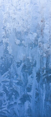 Winter patterns on the glass. Winter cold background for text. Frost. Weather forecast. 