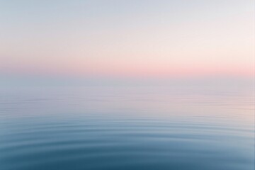 Obraz premium Tranquil Ocean Surface at Dusk with Gentle Ripples and Soft Pastel Sky