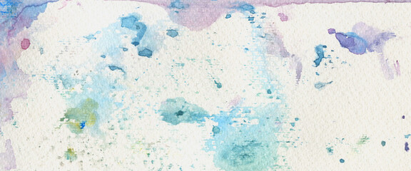 Color watercolor splashes on genuine paper. Colourful watercolour background. Abstract aquarelle brush strokes texture. Artistic banner template background.