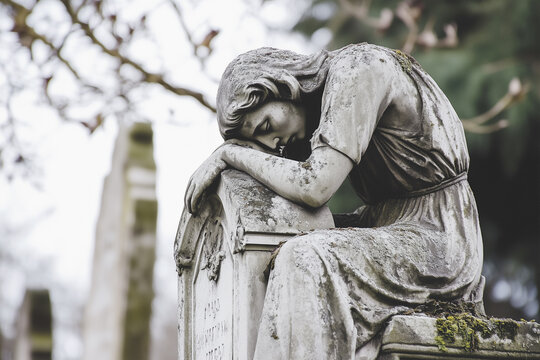 Stone angel mourns in serene cemetery, evoking peaceful reflection on life and loss