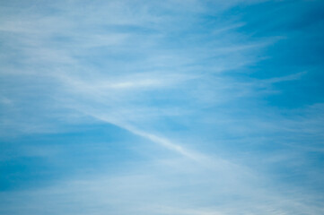 blue background, photo shows sky and light white clouds
