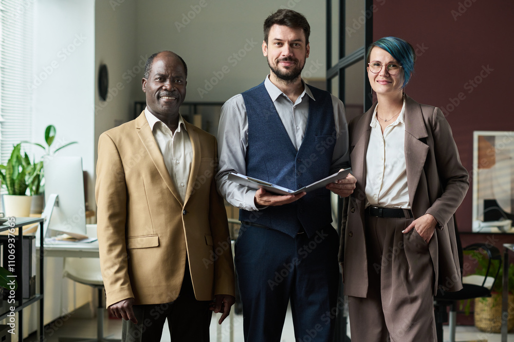 Poster group of three successful intercultural brokers in formalwear looking at camera while standing in mo