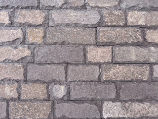 A brick wall with a gray and brown color