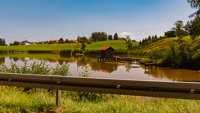 Summer view with reflections in a pond at Rottenbuch, Bavaria, Germany